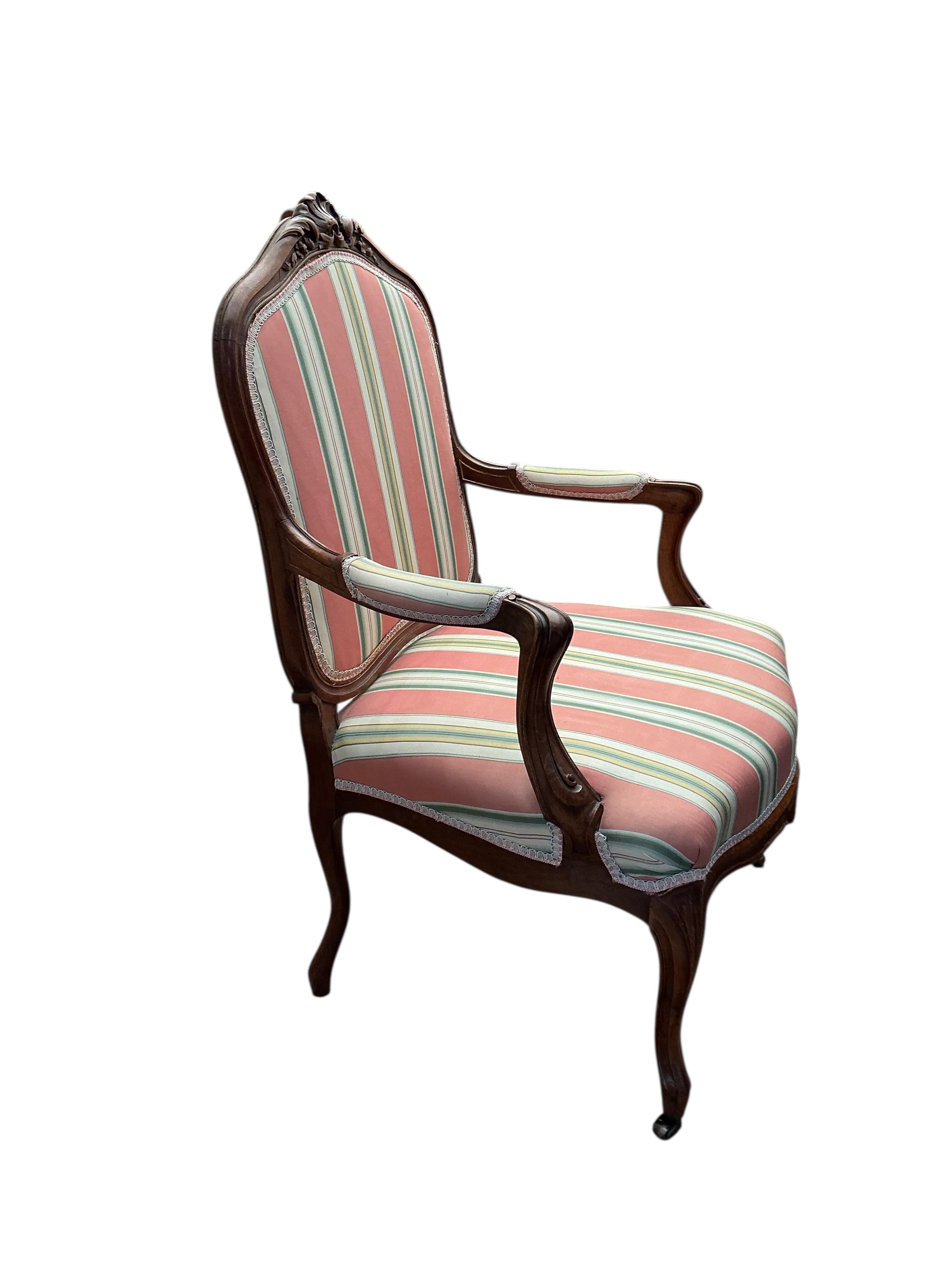 A reproduction Louis XV style walnut upholstered fauteuil, width 66cm, depth 52cm, height 98cm
